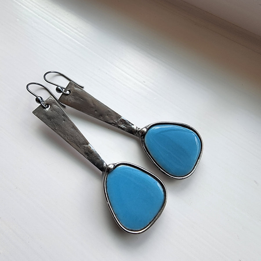 Long dangle earrings with turquoise colored mosaics at the end of a metal band, similar to exclamation mark shape. Comes with Sterling Silver ear wires.