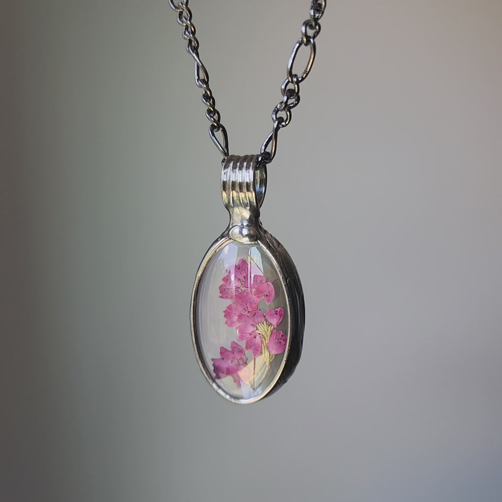 video of real pink heather oval pendant encased in glass. Truly handmade in USA by Louisiana Artisan at Bayou Glass Arts studio.