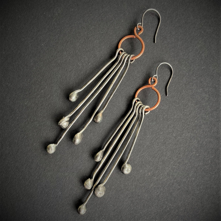 Long Handmade Earrings look like chandeliers. Sterling Silver Ear Wires hold Copper infinity circles that hold 5 individual metal pins with drips on the end. Together these earrings create great movement and are great with long hair or short.