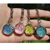 hand_with_four_different_colored_wildflower_necklaces