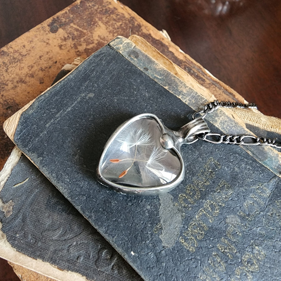 Dandelion Seed Heart Necklace with fully adjustable Figaro Chain with Lobster Claw Closure. Hand Made in Louisiana USA by Artisan at Bayou Glass Arts Studio.