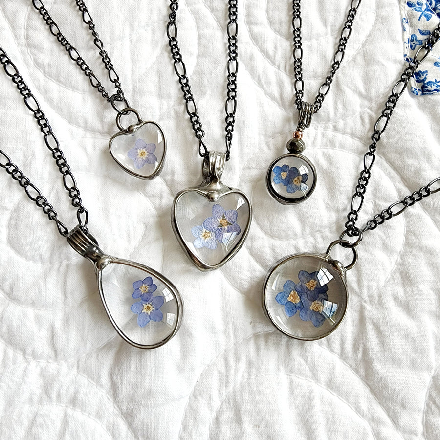 Large assortment of Bayou Glass Arts Hand Made Forget Me Not Pendant Necklaces for women. All shapes and sizes. Hearts, rounds and teardrops 