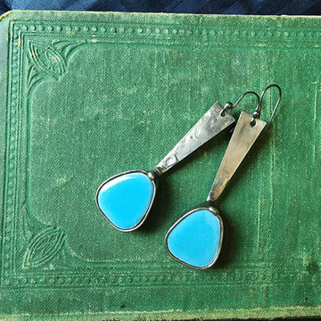 Long dangle earrings with turquoise colored mosaics at the end of a metal band, similar to exclamation mark shape. Comes with Sterling Silver ear wires. 