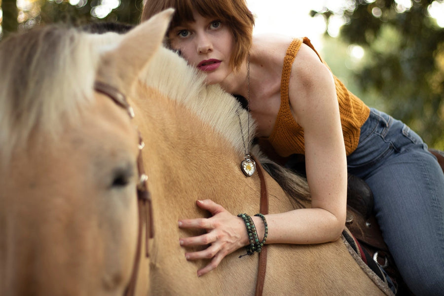 Model on horseback wearing Extra long Daisy heart Pendant
