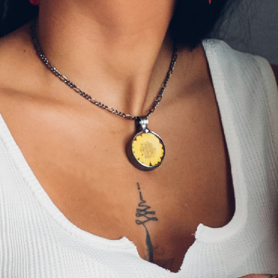 Yellow pressed flower necklace shown on model. Sunflower pendant on fully adjustable figaro chain. Handmade in USA
