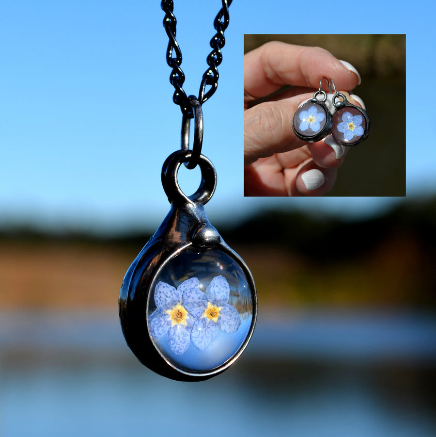 2 bloom blue pressed flower pendant with inset picture of Forget me not earrings on sterling silver ear wires. One blue bloom inside each round glass earring, bezel is hand formed with copper and mixed silver solder by Louisiana Artisan. Hand made in USA.