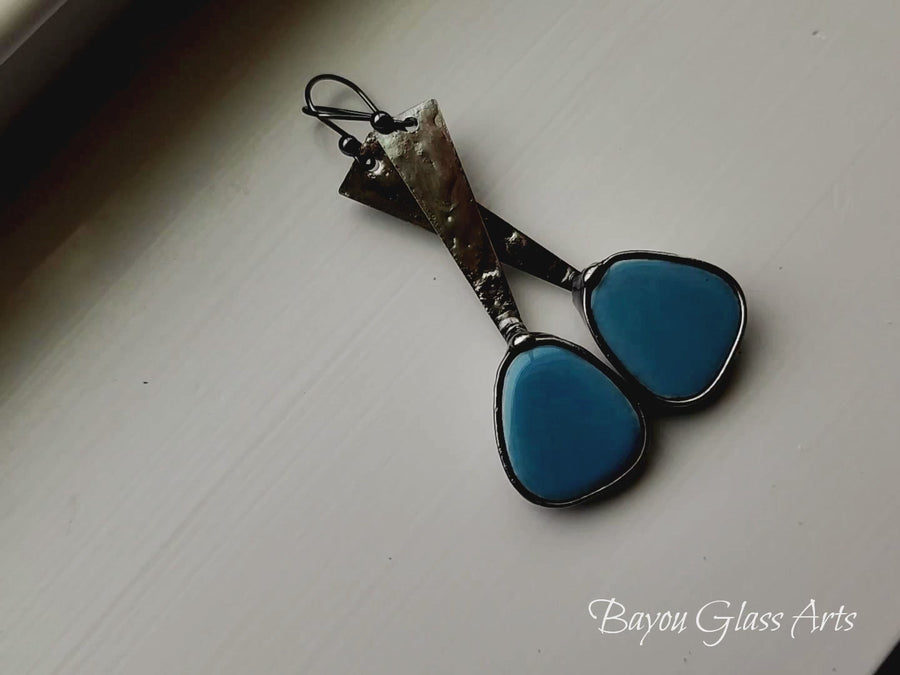 video of Long dangle earrings with turquoise colored mosaics at the end of a metal band, similar to exclamation mark shape. Comes with Sterling Silver ear wires.