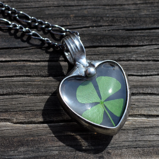 Shamrock in glass heart pendant necklace. Green 4 leaf clover jewelry.Truly Hand Made in USA by Louisiana Artisan at Bayou Glass Arts Studio. Chain is quality plated fully adjustable Figaro style. All are 100% handmade from metals that contain NO lead, cadmium, zinc or nickel. 