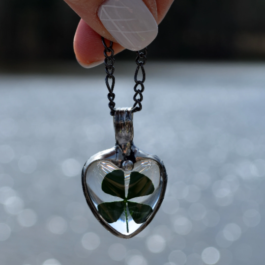 Four leaf clover in glass heart pendant necklace. Truly Hand Made in USA by Louisiana Artisan at Bayou Glass Arts Studio. Chain is quality plated fully adjustable Figaro style. All are 100% handmade from metals that contain NO lead, cadmium, zinc or nickel. 