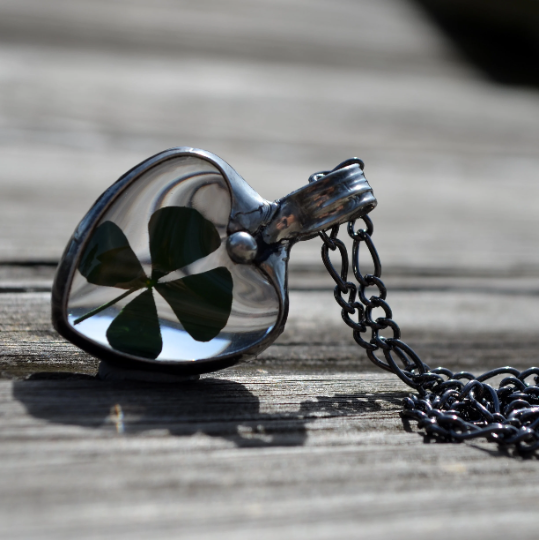 4 leafed clover in glass heart pendant necklace for women.Truly Hand Made in USA by Louisiana Artisan at Bayou Glass Arts Studio. Chain is quality plated fully adjustable Figaro style. All are 100% handmade from metals that contain NO lead, cadmium, zinc or nickel. 