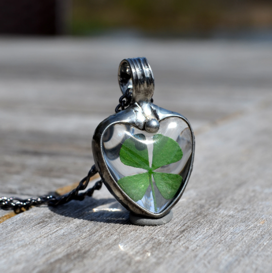 Four leaf clover shamrock in glass heart pendant necklace. Truly Hand Made in USA by Louisiana Artisan at Bayou Glass Arts Studio. Chain is quality plated fully adjustable Figaro style. All are 100% handmade from metals that contain NO lead, cadmium, zinc or nickel. 
