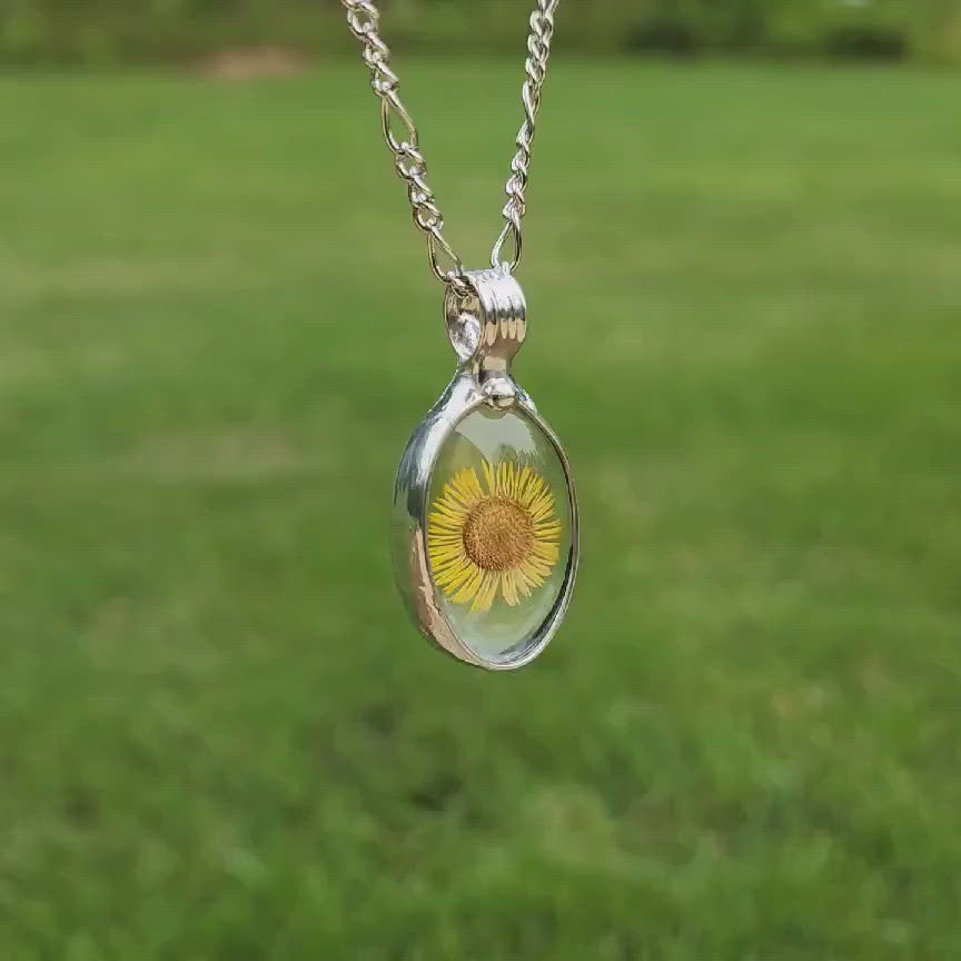 Oval Yellow Aster Pendant with Shiny silver finish. Delicate Sunflower. Real Pressed Flower Jewelry. Truly Hand Made in USA by Artisans at Bayou Glass Arts in Louisiana. 