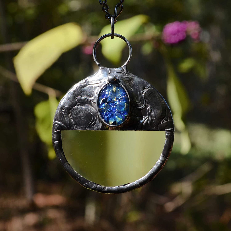 Magnifying glass pendant with blue opal inset