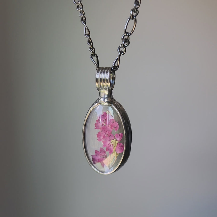 video of real pink heather oval pendant encased in glass. Truly handmade in USA by Louisiana Artisan at Bayou Glass Arts studio.