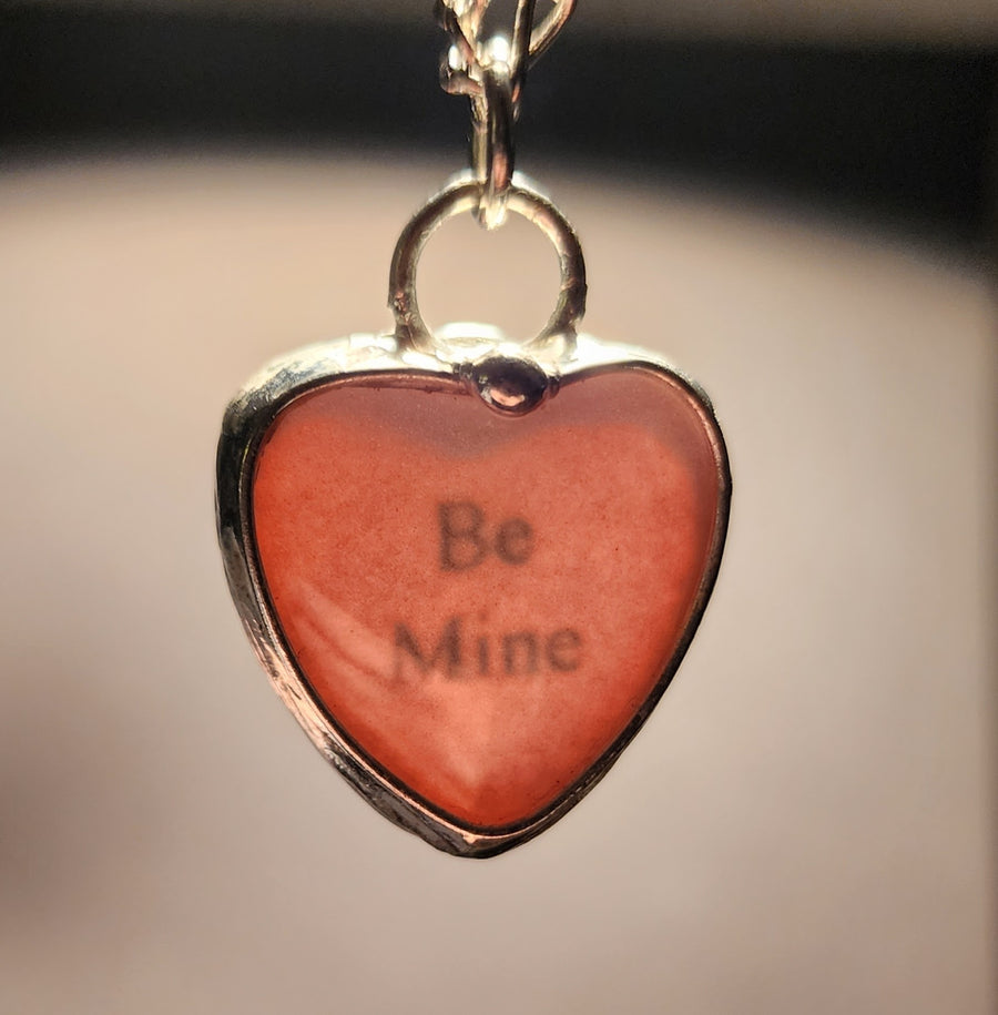 Handmade See See Heart Pendant Necklace that is backlit to show the hidden message inside, Be Mine. Conversation heart to wear everyday.