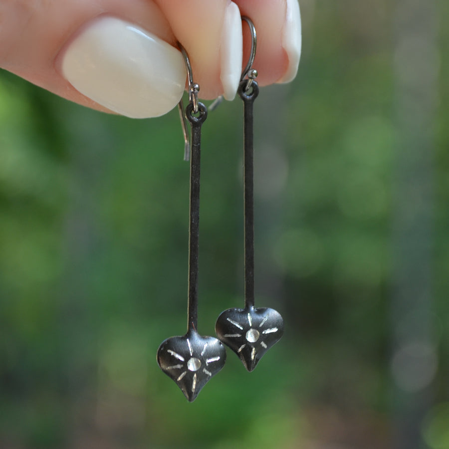 Set of gunmetal dangle earrings with hearts and starburst