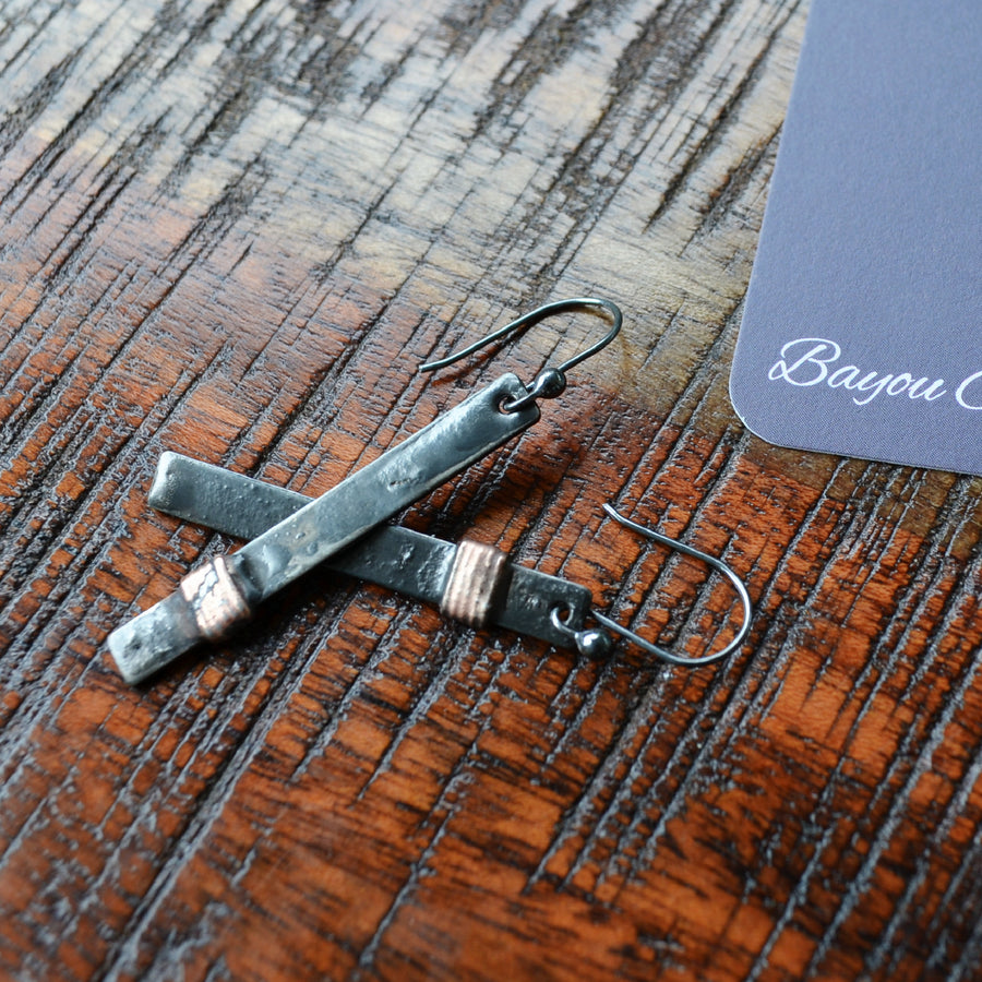 Mixed metal asymmetrical bar earrings, hand formed oxidized sterling silver ear wires, wire wrap with copper. Best for everyday wear. Truly hand made in USA by Louisiana Artisans at Bayou Glass Arts Studio.