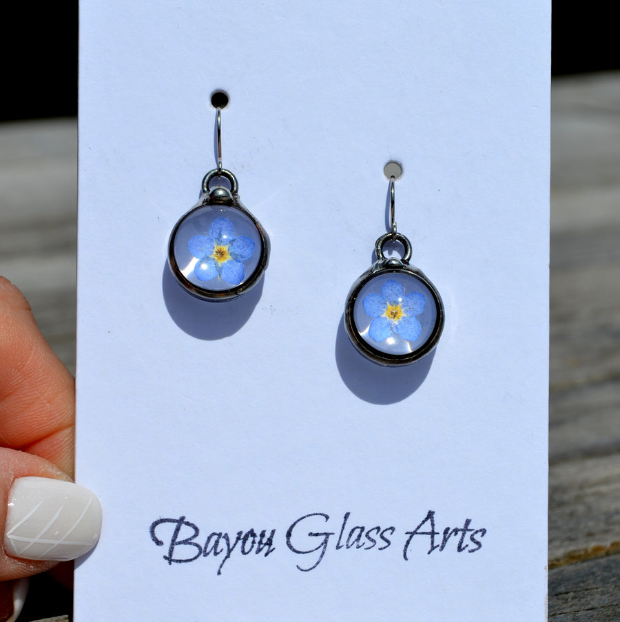 Handmade Real Dry Pressed Flower forget me not earrings, hand formed oxidized sterling silver ear wires. Truly Hand Made in USA by Louisiana Artisan at Bayou Glass Arts Studio.