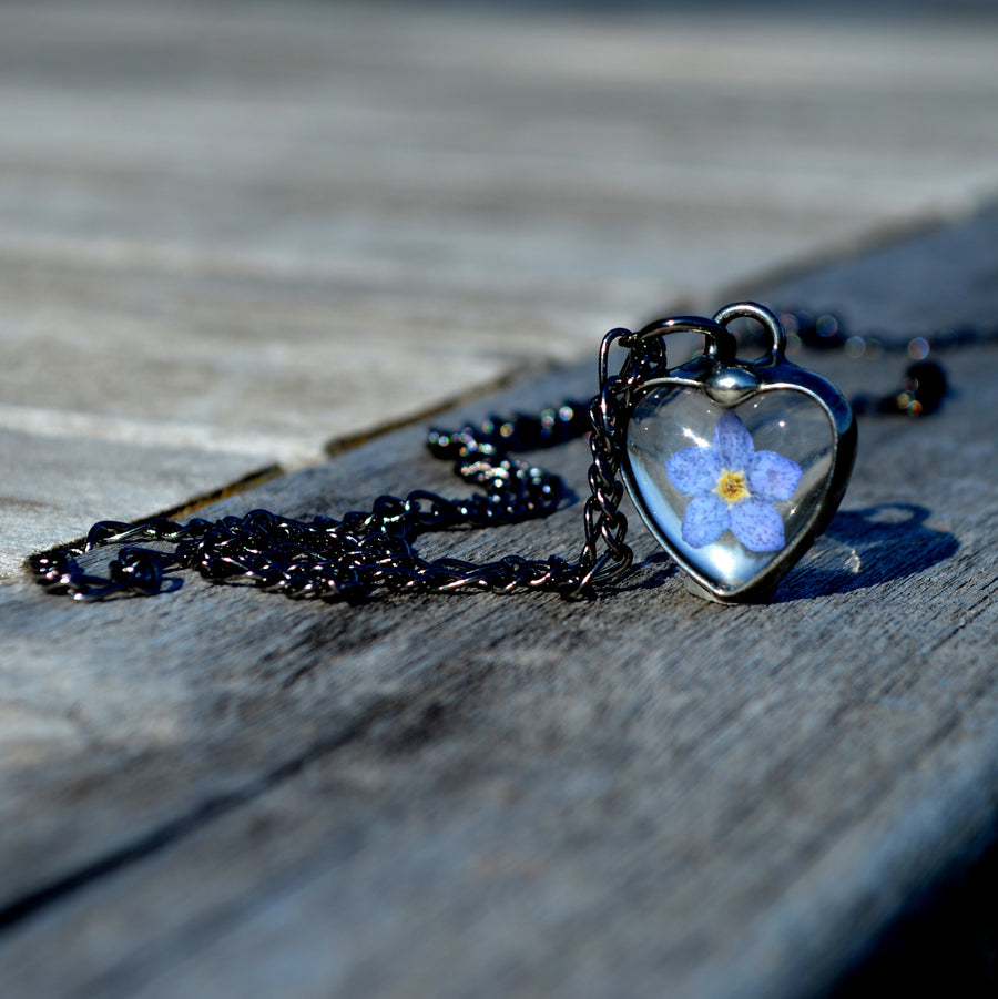 Tiny forget me not charm pendant necklace with one pressed flower bloom. Truly hand made in USA by Louisiana Artisan at Bayou Glass Arts Studio.
