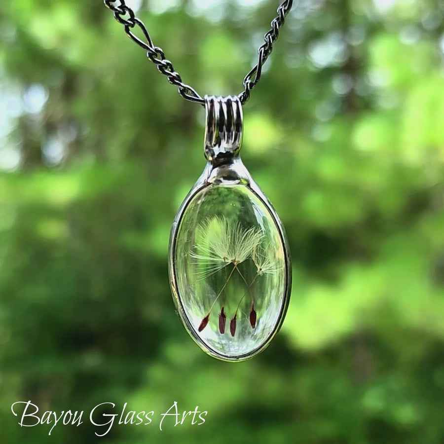 Dandelion Seed Wish Necklace video, showing the oval shaped pendant filled with 1, 2, 3 or 4 dandelion seeds.