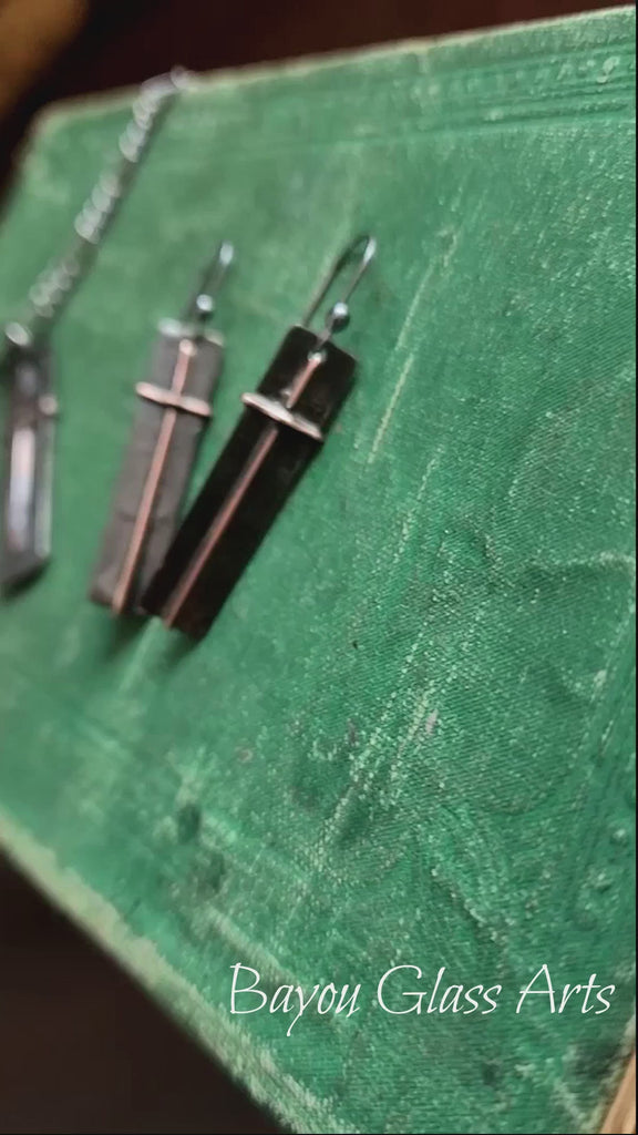 Video of Metal Cross Earrings and Pendant laid on a book. Truly Handmade in USA by Louisiana Artisan at Bayou Glass Arts Studio,
