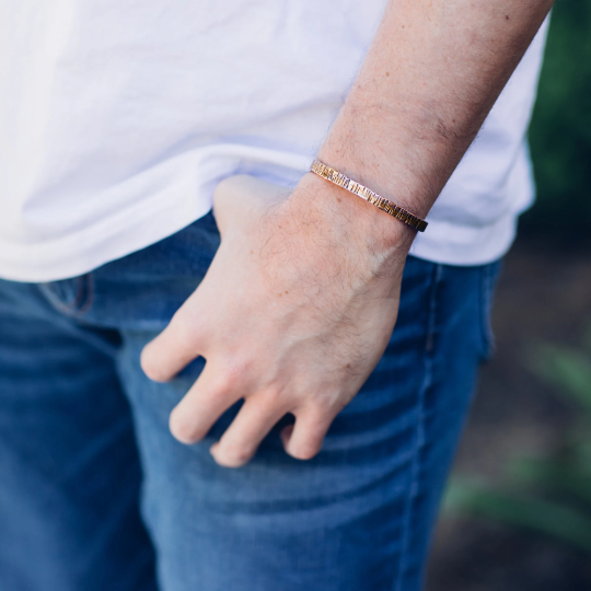  male model wearing 1 copper cuff bracelet.  Comes in 3 styles.Full hand hammered, edge and bark. Each has a different look. Truly Hand made in Louisiana USA at Bayou Glass Arts Studio.
