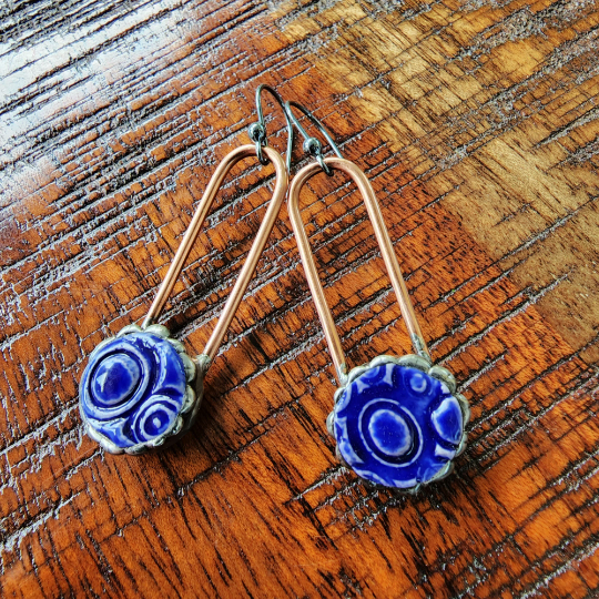 blue ceramic dot earrings on copper wires, dangle earrings attached to sterling silver ear wires. Truly Hand Made In USA by Louisiana Artisan at Bayou Glass Arts Studio.