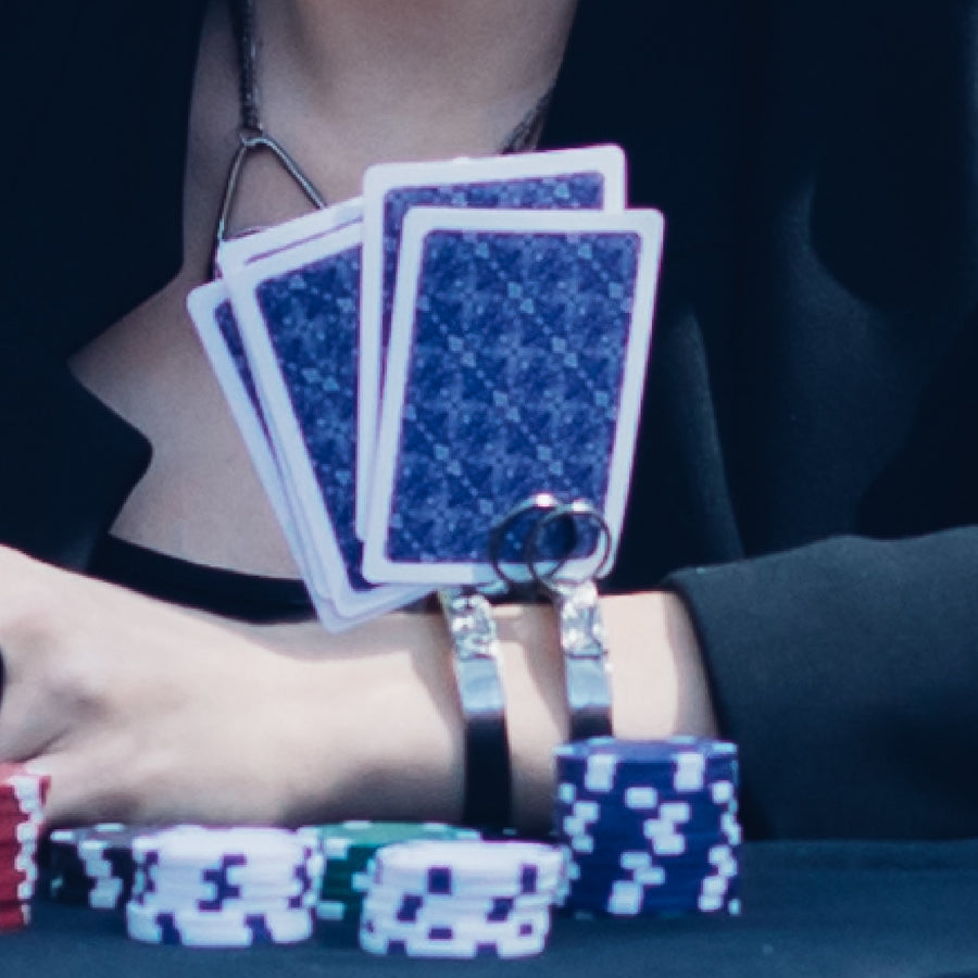 Model playing cards and holding her cards in her one of a kind bracelet from Bayou Glass Arts. Metal bracelet cuff with rounded wires that will hold your cards upright.