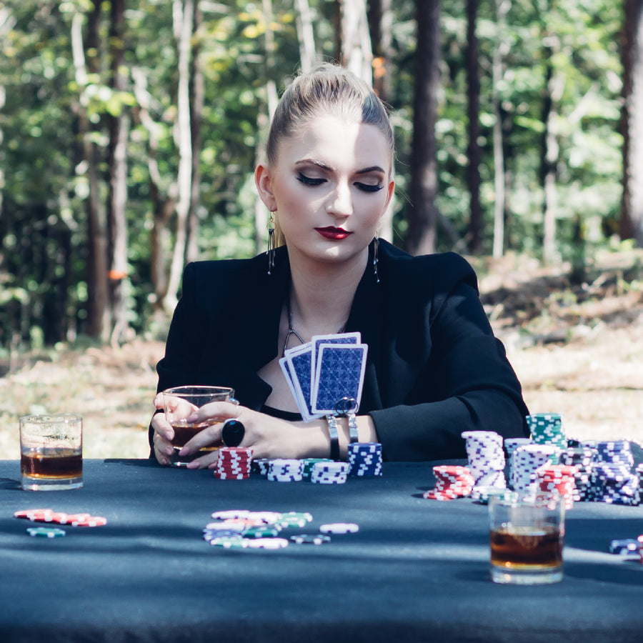 Model playing cards and holding her cards in her one of a kind bracelet from Bayou Glass Arts. Metal bracelet cuff with rounded wires that will hold your cards upright.