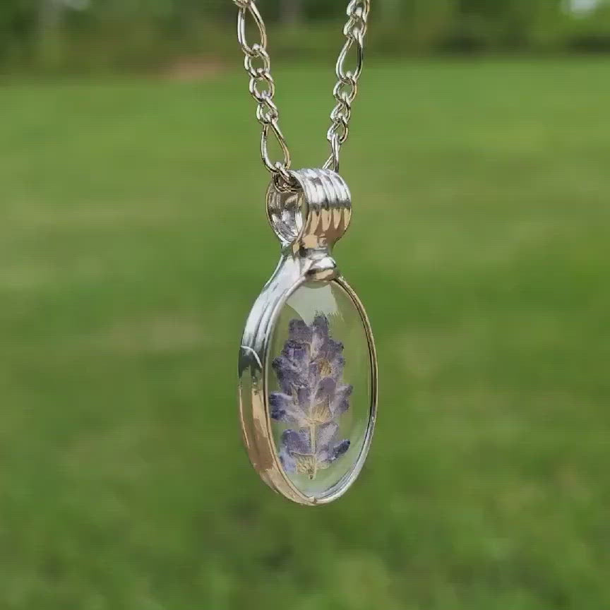 Lavender oval boho pendant, Purple Pressed Flowers in Shiny Silver Finish. Glass pendant is truly Hand Made in USA by Artisans at Bayou Glass Arts studio in Louisiana.