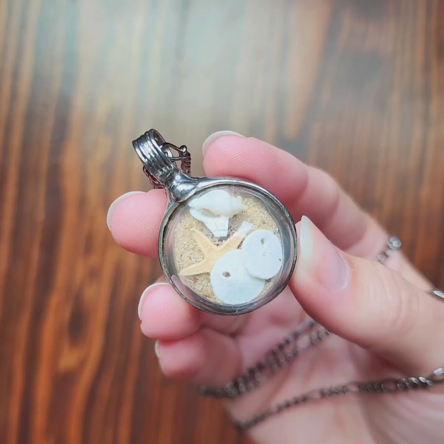 Video of Beach Terrarium Necklace. Comes with sand and starfish plus. This terrarium necklace is truly hand made in Louisiana USA.