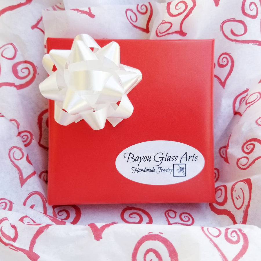 Valentine's Day Gift Wrapping by Bayou Glass Arts. High quality red wrapping paper with coordinated bow. Then wrapped in designer tissue paper before it goes in the shipping box. No charge to add a Gift message.