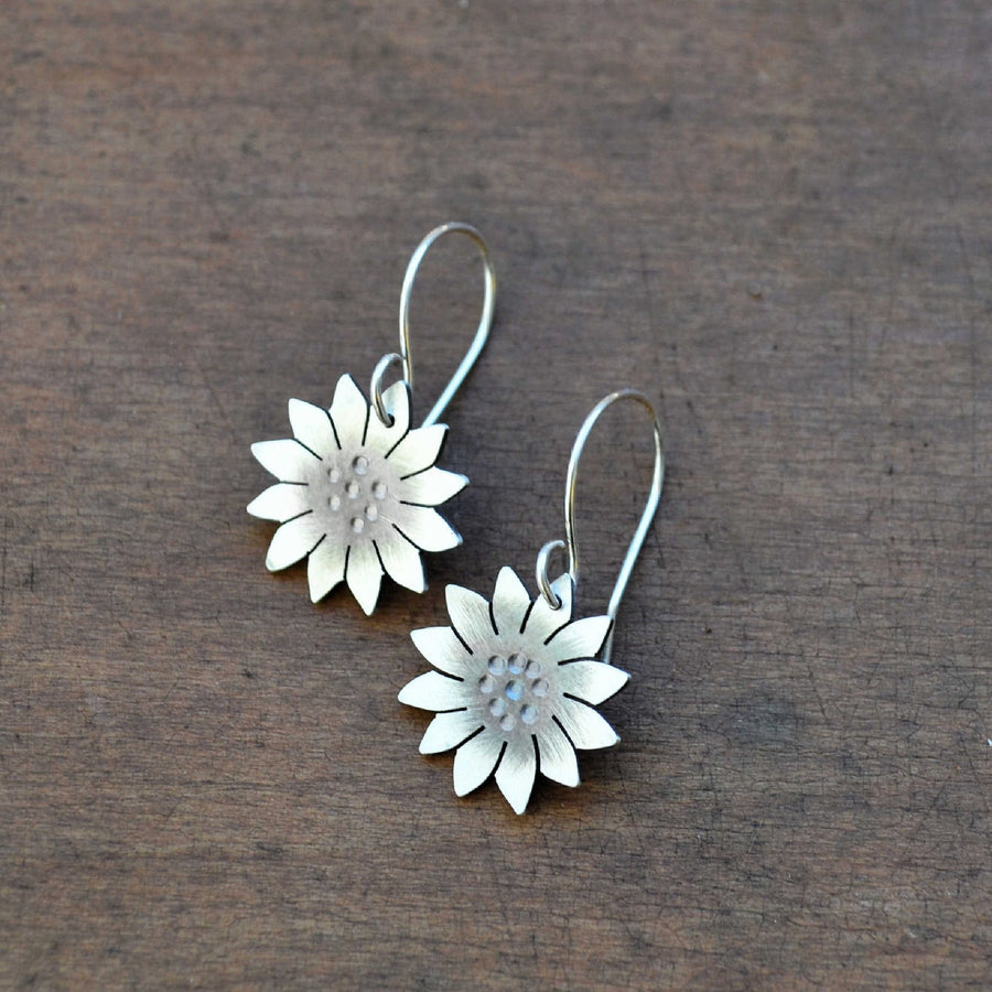 hand hammered and cut sterling silver sunflower earrings. Truly hand made in USA by Louisiana Artisan at Bayou Glass Arts studio.