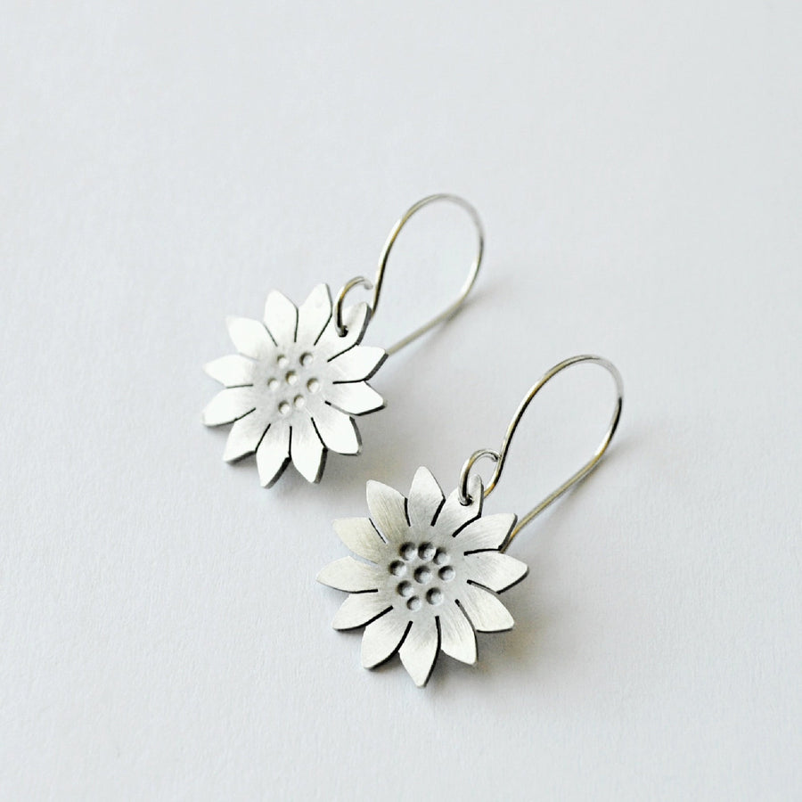 hand hammered and cut sterling silver sunflower earrings. Truly hand made in USA by Louisiana Artisan at Bayou Glass Arts studio.