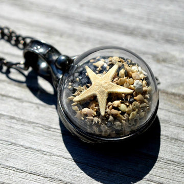 Handmade Okinawa Beach Sand Pendant Necklace with Starfish and shells. Truly Handmade in USA by Louisiana Artisan at Bayou Glass Arts Studio. Magnified on back of jewelry.