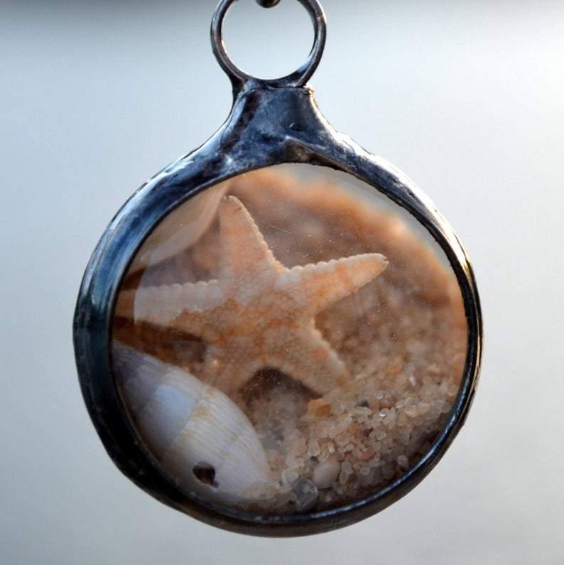 Back_Beach_Terrarium_Jewelry Beach Terrarium Orb Necklace filled with starfish sand and shells. One side is magnified. Loose items create this shaker pendant. Truly Hand Made in USA by Louisiana Artisan at Bayou Glass Arts. Great gift for Mom wife girlfriend grandmother sister Christmas Birthday