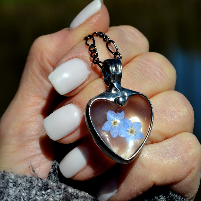 Forget me not heart pendant with 2 blue blooms under glass. Bezel is hand formed with copper and mixed silver solder by Louisiana Artisan. Hand made in USA. Mother daughter gift for mothers day.