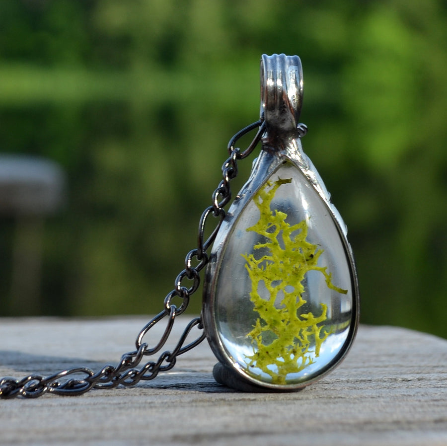 Green Moss in between 2 pear shaped glass cabochons making a beautiful pendant and necklace