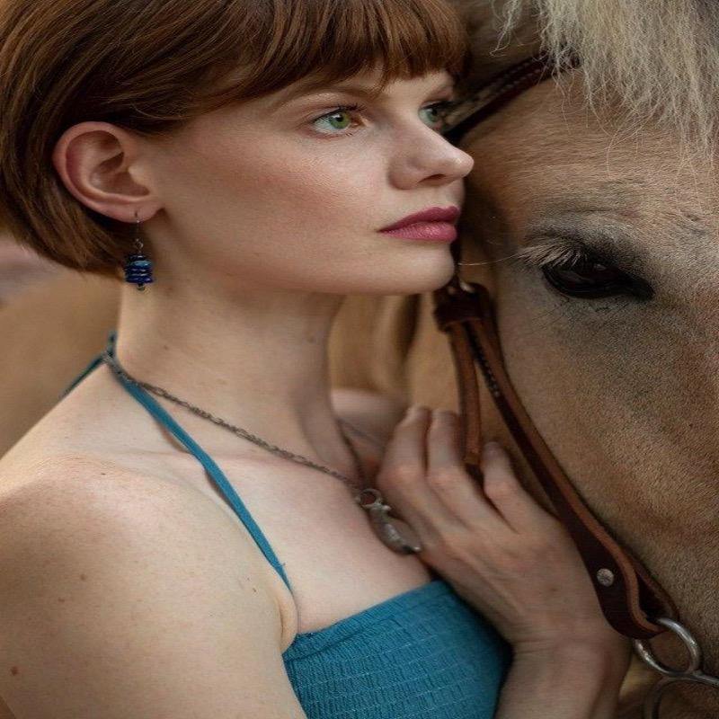 Blue_earrings_on_model_with_horse