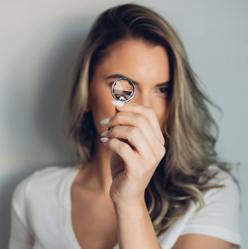 Model looking through the Infinity Kaleidoscope Pendant. Truly Hand Made in USA by Louisiana Artisan at Bayou Glass Arts Studio. Great Gift for Her