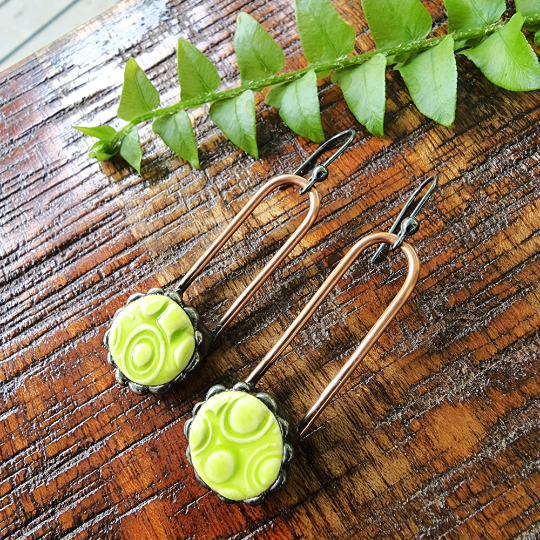 lime green ceramic dot earrings on copper wires, dangle earrings attached to sterling silver ear wires. Truly Hand Made In USA by Louisiana Artisan at Bayou Glass Arts Studio.