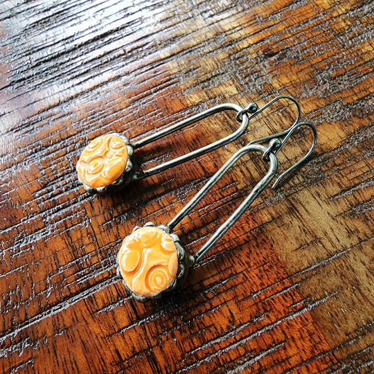 orange ceramic dot earrings on copper wires, dangle earrings attached to sterling silver ear wires. Truly Hand Made In USA by Louisiana Artisan at Bayou Glass Arts Studio.